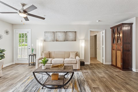 a living room with a couch and a ceiling fan